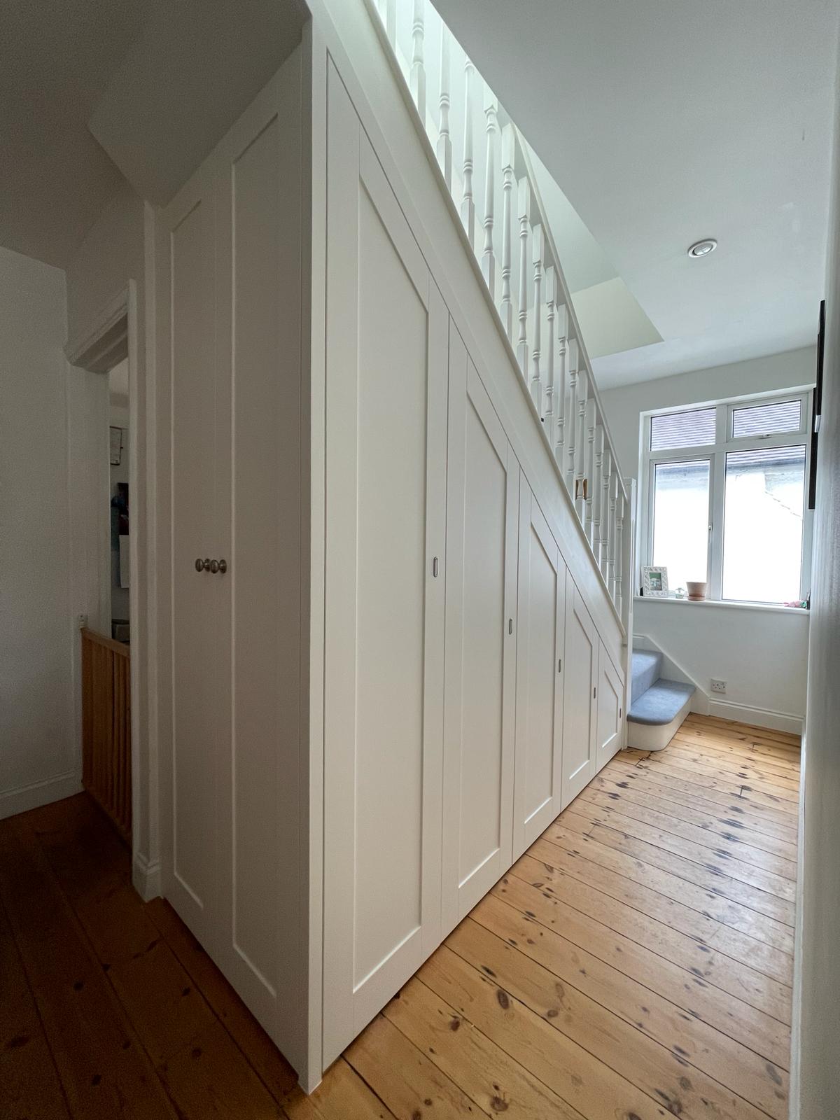 Custom under-stairs cupboard with pull-out storage in Ascot