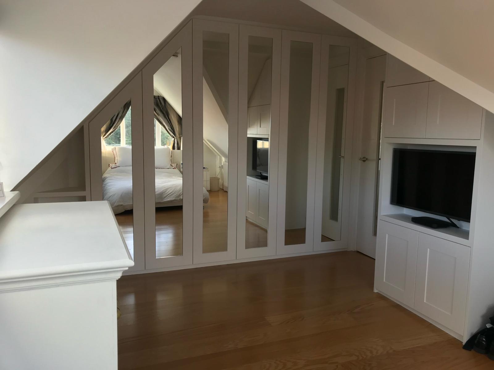 Bespoke eaves cupboards with pull-out drawers in Berkshire loft
