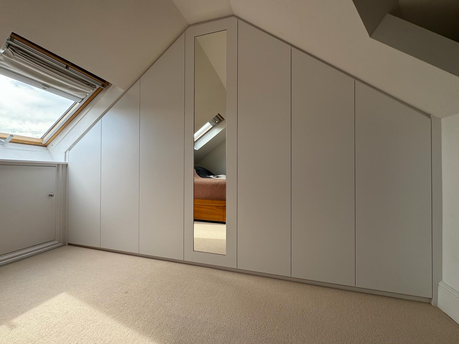 Custom fitted eaves storage with painted doors in Berkshire